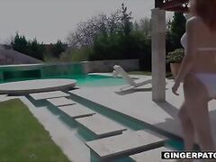 Redhead plays with herself by the pool before getting fucked