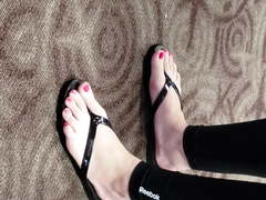 Feet in flip flops at airport