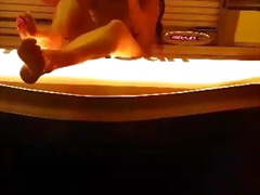 Voyeur - Spying brunette in the solarium under the door